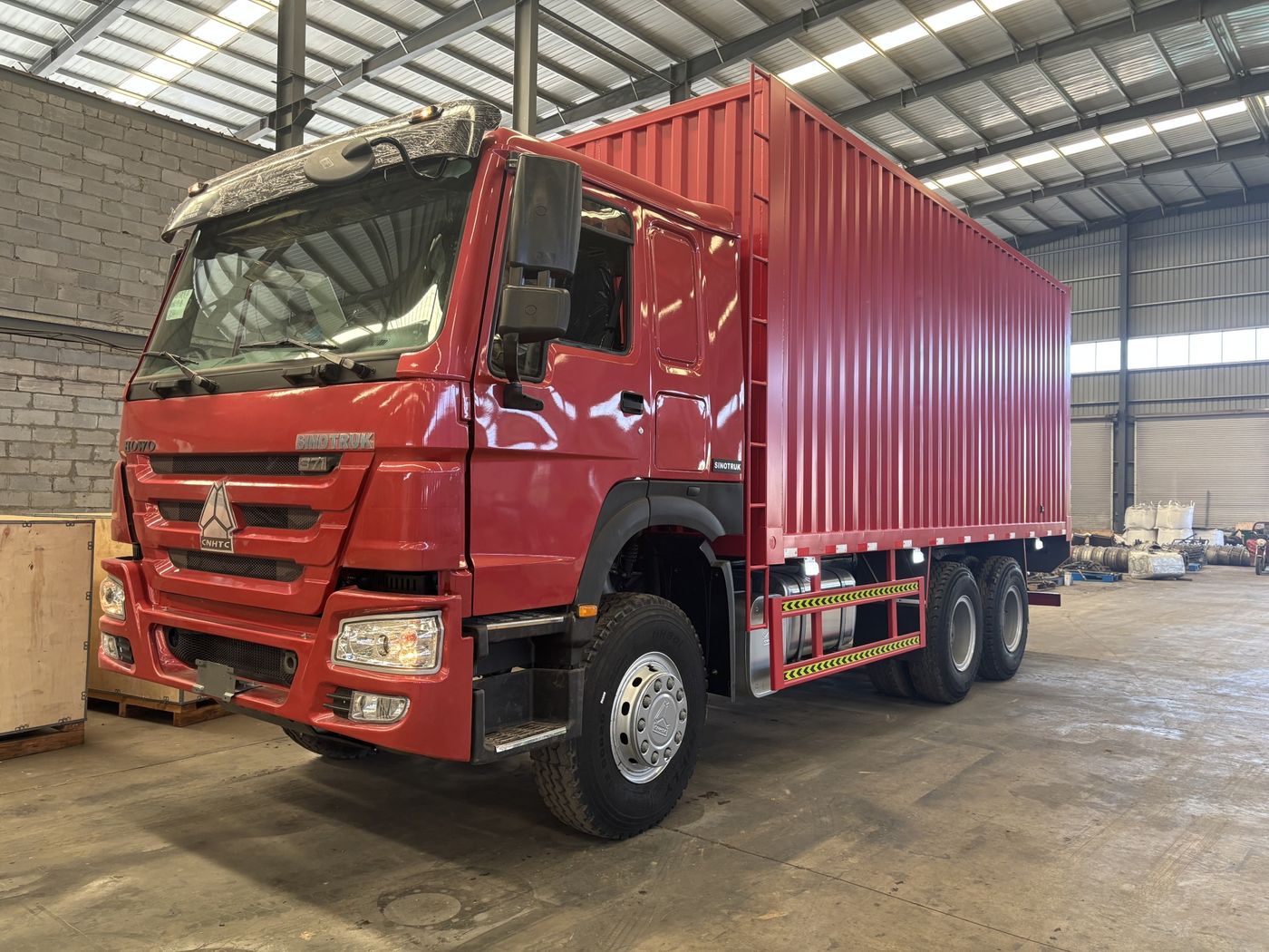 Red HOWO 371 6x4 box van truck, current vehicle photo