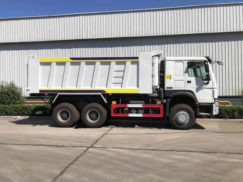 Side view of HOWO 6×4 Dump Truck showing dump body and chassis at factory.