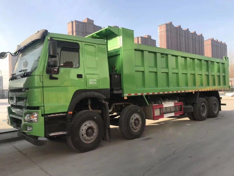 Rear 3/4 view of HOWO 8×4 Dump Truck in SINOTRUK pre-shipment inspection yard.