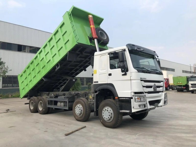 HOWO 8×4 Dump Truck rear view with cargo box lifted in factory test area.
