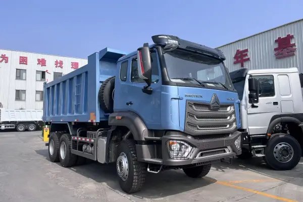 HOWO NX 6×4 dump truck H77L cab detail with HOWO front grille, headlights and front axle structure.